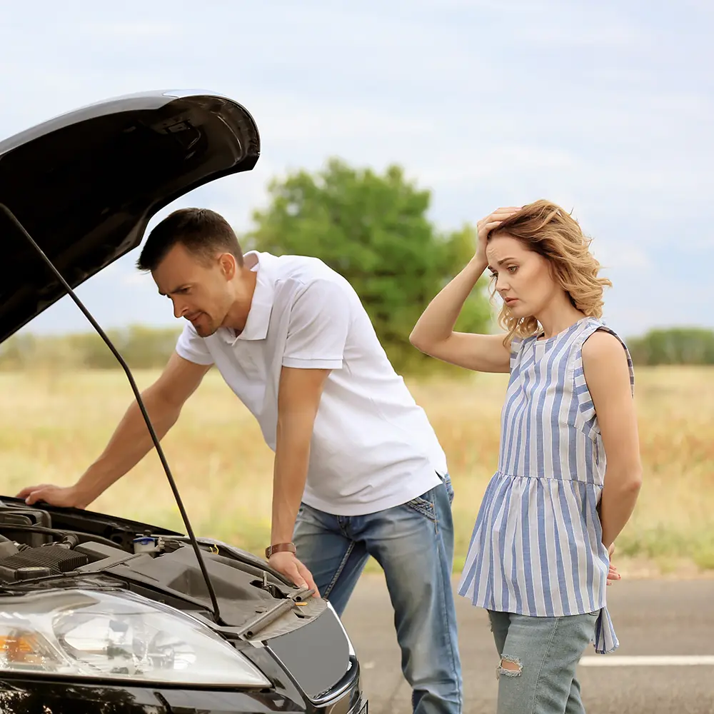 couple with broken down car